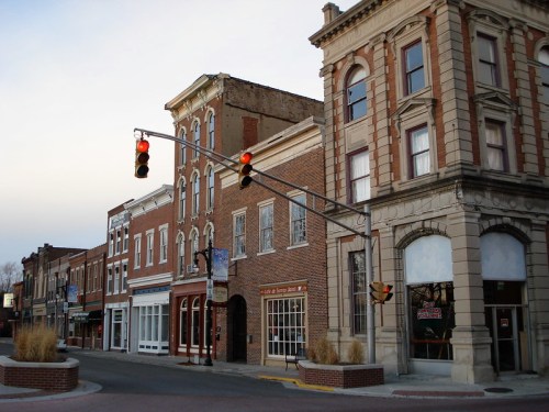 Historic downtown street with brick buildings and a traffic light showing red.