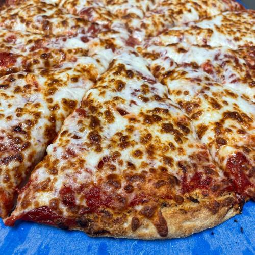 Close-up of a cheesy pizza with golden-brown melted cheese and a crispy crust, featuring several slices.