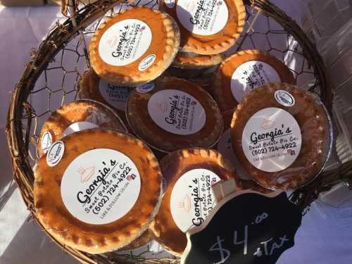 A basket filled with small pies labeled "Georgia's Sweet Potato Pie Co." priced at $4.00 each.