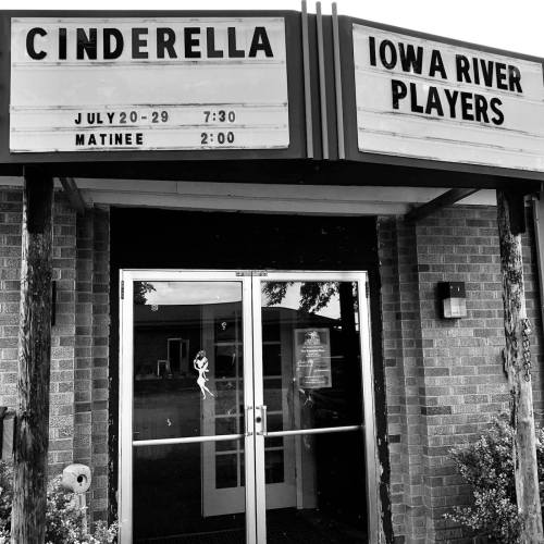 Sign for a theater performance of "Cinderella" by Iowa River Players, with show dates and times listed.