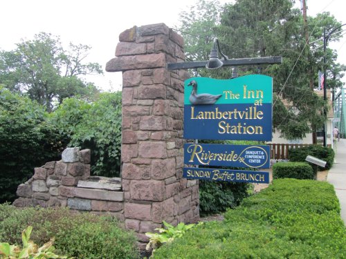 Sign for "The Inn at Lambertville Station" featuring a duck, with details about a banquet center and Sunday brunch.