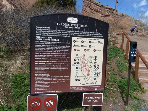 Sign with trail information and safety tips for the Trading Post Trail, featuring a map and guidelines for hikers.