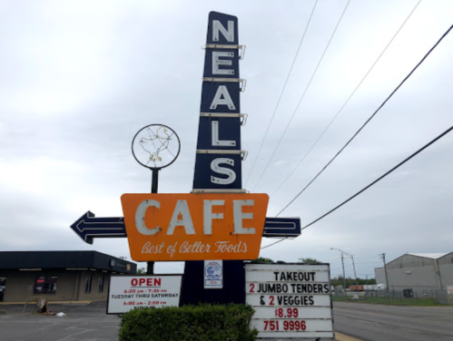 Sign for Neal's Cafe featuring "Best of Better Foods," with hours and a takeout special for jumbo tenders and veggies.