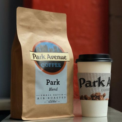 A bag of Park Avenue Coffee's Park Blend next to a coffee cup featuring the same branding.