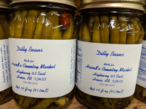 Two jars of "Dilly Beans" from Heard's Country Market, labeled with ingredients and location details.