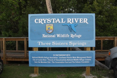 Sign for Crystal River National Wildlife Refuge, featuring "Three Sisters Springs" and partnership details below.