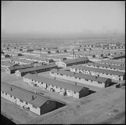 Aerial view of a large, sprawling complex of single-story buildings in a rural landscape.