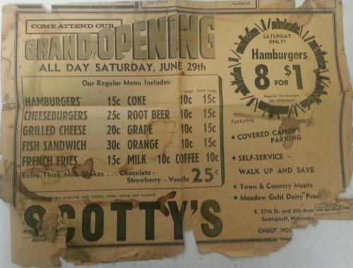 Vintage advertisement for a grand opening featuring menu items and prices, including hamburgers, fries, and drinks.