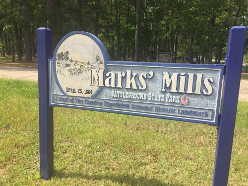 Sign for Marks' Mills Battleground State Park, featuring a historical illustration and the date April 25, 1864.