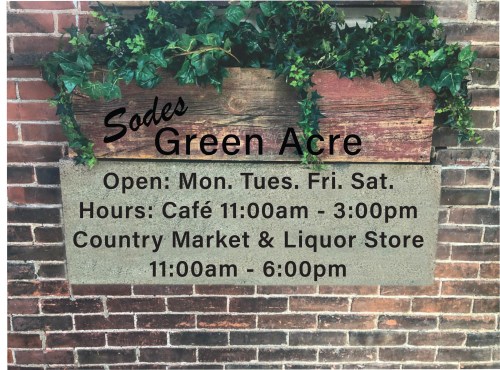 Sign for Sodes Green Acre with hours for café, country market, and liquor store. Open Monday, Tuesday, Friday, and Saturday.