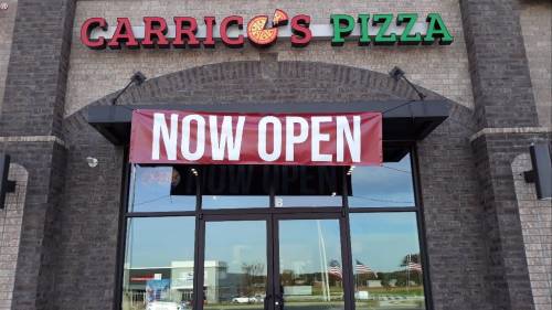 Signage for Carrico's Pizza with a large "NOW OPEN" banner displayed at the entrance.