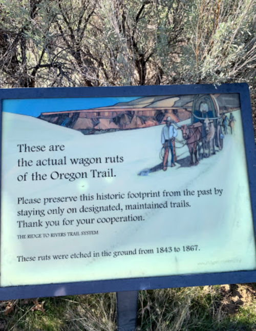 Sign describing the historic wagon ruts of the Oregon Trail, urging preservation and cooperation.