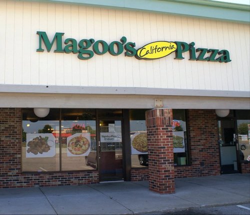 Exterior of Magoo's California Pizza, featuring a sign and large windows displaying food images.