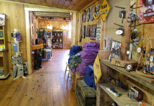 A rustic shop interior with wooden walls, shelves of merchandise, and a cozy atmosphere.