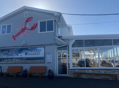 Exterior of a seafood restaurant with a lobster mural, large windows, and a sign reading "Lobster Restaurant & Market."