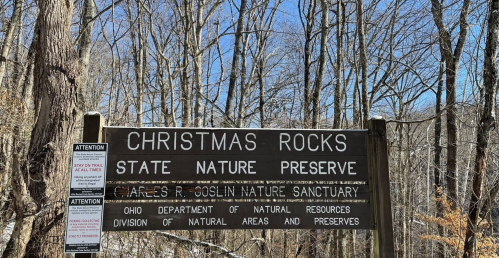 Sign for Christmas Rocks State Nature Preserve, featuring information about the sanctuary and natural resources.