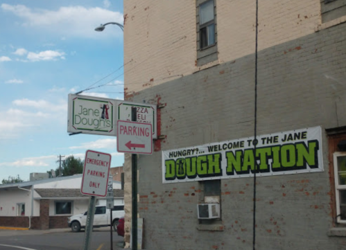 Signage for "Jane Dough's" and "Dough Nation," with parking directions and a welcoming message for customers.