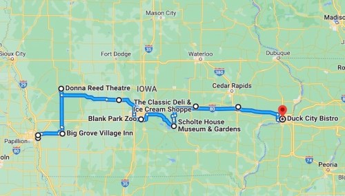 Map showing a route through Iowa, highlighting locations like Donna Reed Theatre and Duck City Bistro.