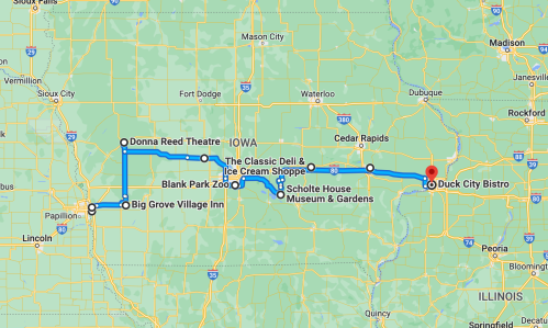 Map showing a route through Iowa, highlighting stops like Duck City Bistro and Big Grove Village Inn.