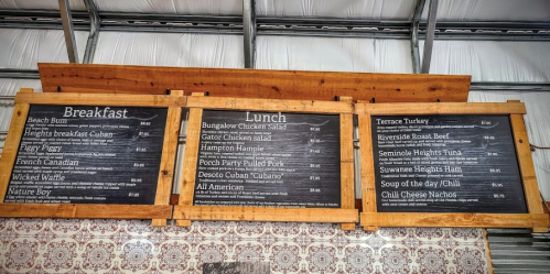 Menu board displaying breakfast and lunch options, including items like Gator Chicken Salad and Terrace Turkey.