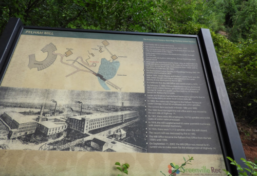 Historical sign about Pelham Mill, featuring a map and timeline of events related to the mill's history.