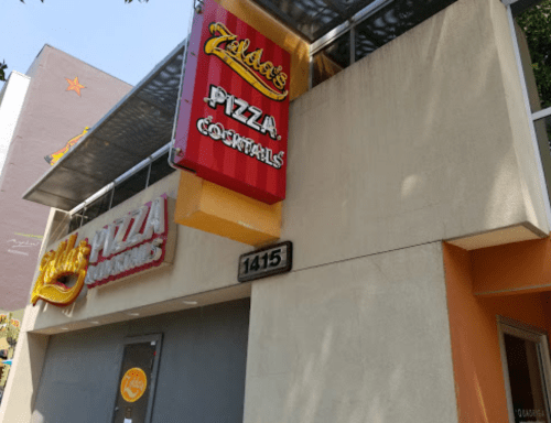 Signage for Zilda's Pizza and Zilda's Pizza Corrals on a building exterior, featuring bright colors and a modern design.