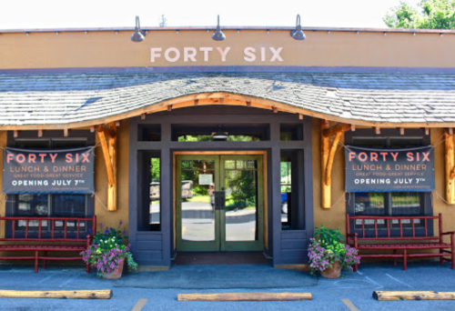 Exterior of a restaurant named "Forty Six," featuring a welcoming entrance and signs announcing its opening on July 7th.