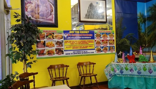 A colorful restaurant interior featuring a menu banner and festive decorations on a table.