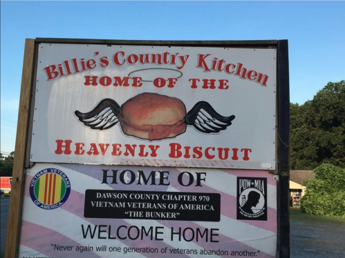 Sign for Billie's County Kitchen, featuring "Heavenly Biscuit" and information about local veterans' organizations.