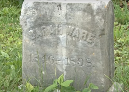 A weathered gravestone reads "Sarah Ware 1846-1898," surrounded by grass and greenery.