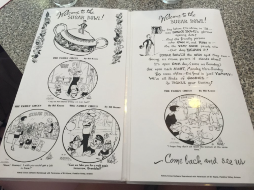 Menu cover for "The Sugar Bowl!" featuring cartoon illustrations and welcoming text about family and dining.