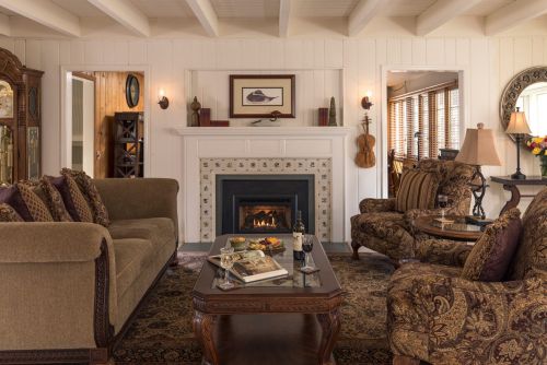 Cozy living room with a fireplace, elegant furniture, and warm lighting, creating a welcoming atmosphere.
