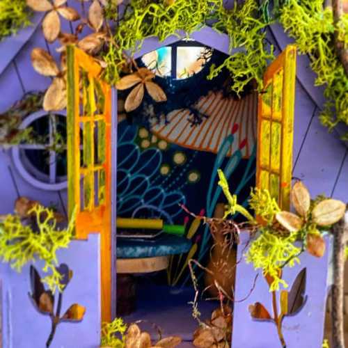 A whimsical purple house with open doors, adorned with flowers and moss, revealing a colorful interior.