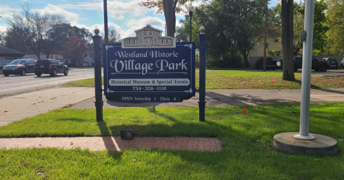 Sign for Westland Historic Village Park, featuring information about the historical museum and special events.