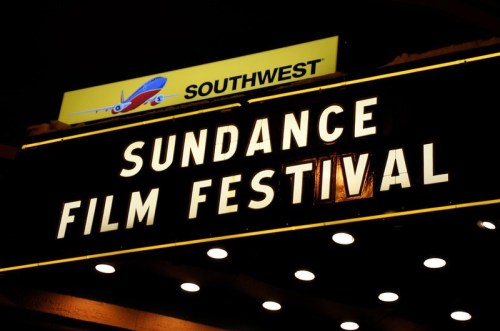 Sign for the Sundance Film Festival illuminated at night, with a Southwest Airlines logo above.
