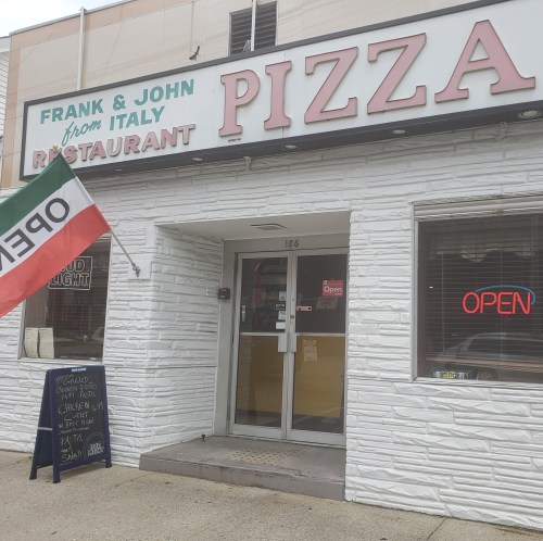Exterior of Frank & John from Italy Pizza restaurant, featuring a sign that says "OPEN" and an Italian flag.