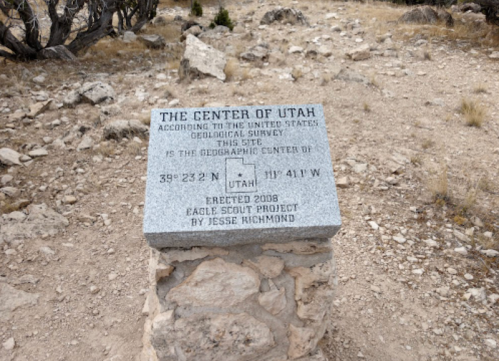 A stone marker indicating the geographic center of Utah, with coordinates and details about its establishment in 2008.