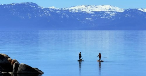 Two people paddleboarding on Lake Tahoe in Nevada.