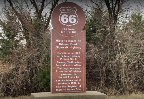 Sign marking Historic Route 66, detailing its history and significance as a former federal highway in Oklahoma.