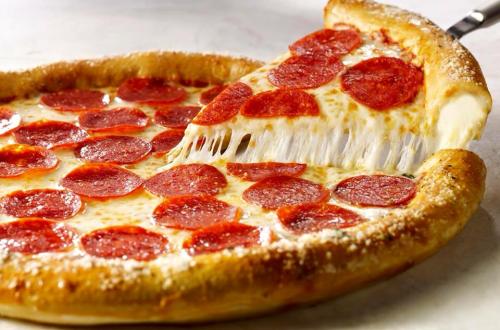 A delicious pepperoni pizza with a cheesy, golden crust, and a slice being lifted, showcasing its gooey cheese.