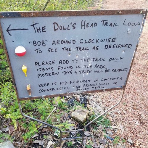 Sign for the Doll's Head Trail Loop, instructing visitors on trail use and item guidelines.