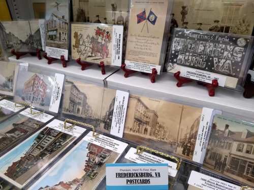 A display of vintage postcards featuring Fredericksburg, VA, showcasing various historical scenes and greetings.