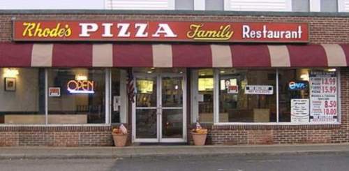 Front view of Rhodie's Pizza Family Restaurant, featuring a red and white awning and an "OPEN" sign.