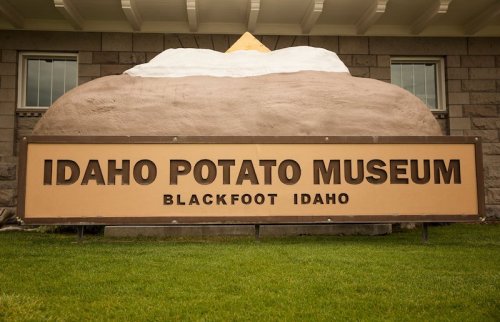 Sign for the Idaho Potato Museum in Blackfoot, Idaho, featuring a large potato sculpture above the text.