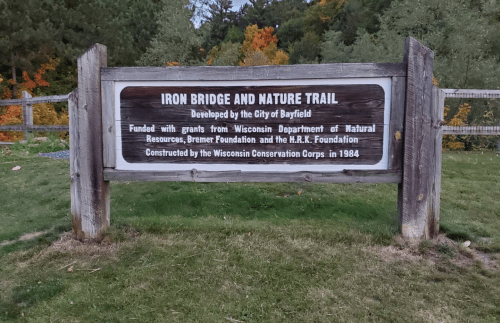 Sign for Iron Bridge and Nature Trail, developed by the City of Bayfield, with funding details and construction info.
