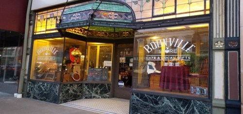 A charming café and gift shop with stained glass windows and a welcoming entrance, featuring local gifts and decor.