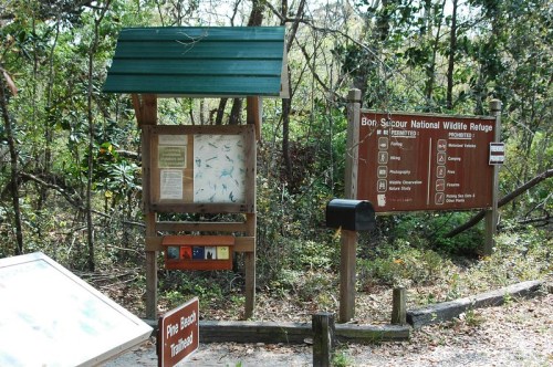 Signage at Bon Secour National Wildlife Refuge, featuring rules, maps, and information about the area.