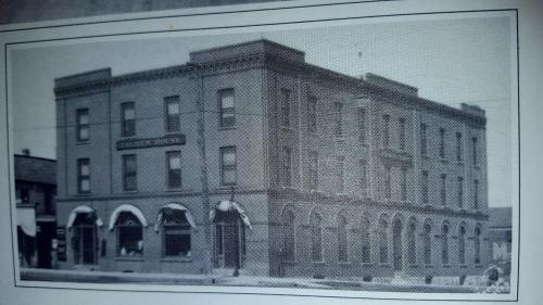Historic black-and-white photo of a three-story building with arched windows, labeled "Columbia House."