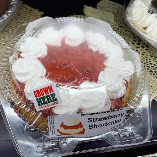 A packaged strawberry shortcake with whipped cream, labeled from Springdale Farm Market.
