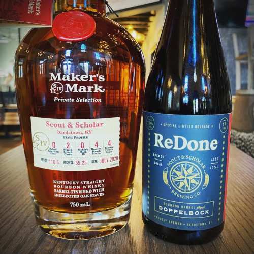A bottle of Maker's Mark bourbon and a bottle of ReDone Doppelbock beer on a table, showcasing their labels.